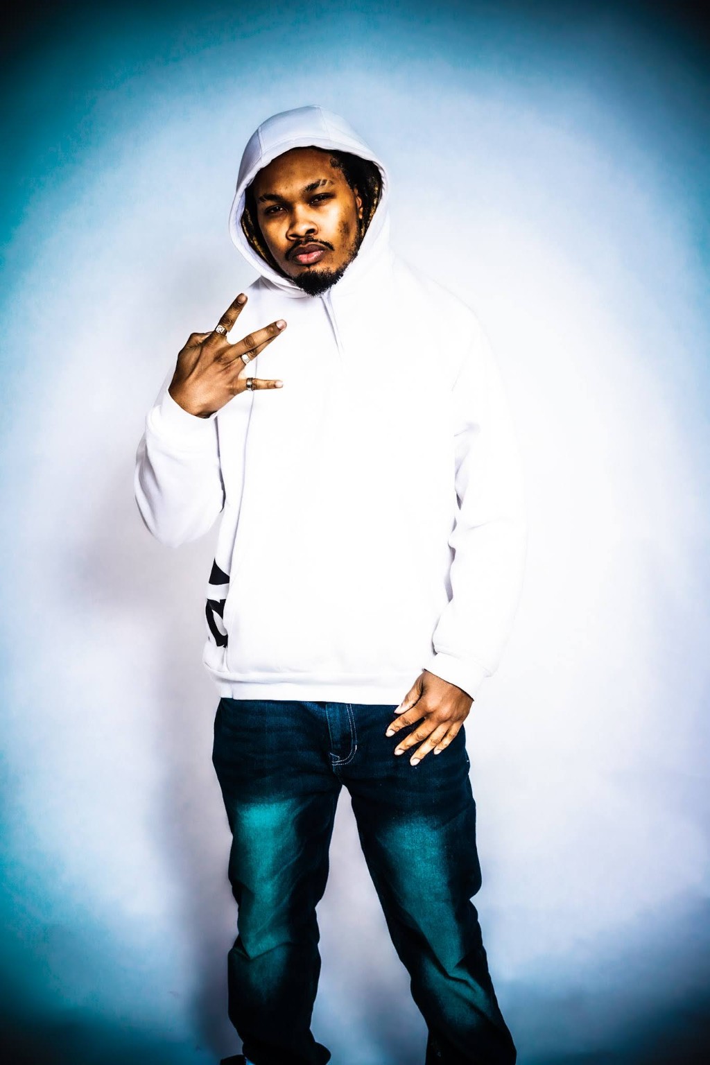 Portrait of Indigo Kirk3 standing in a white hoodie